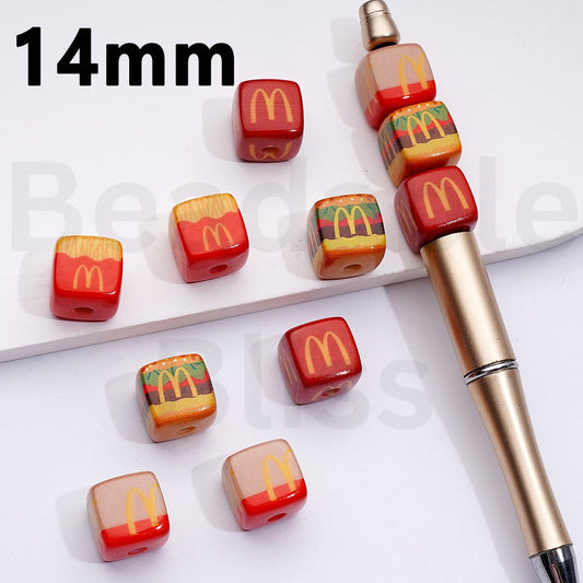 Set of McDonald's-themed beads and a pen on a white background

