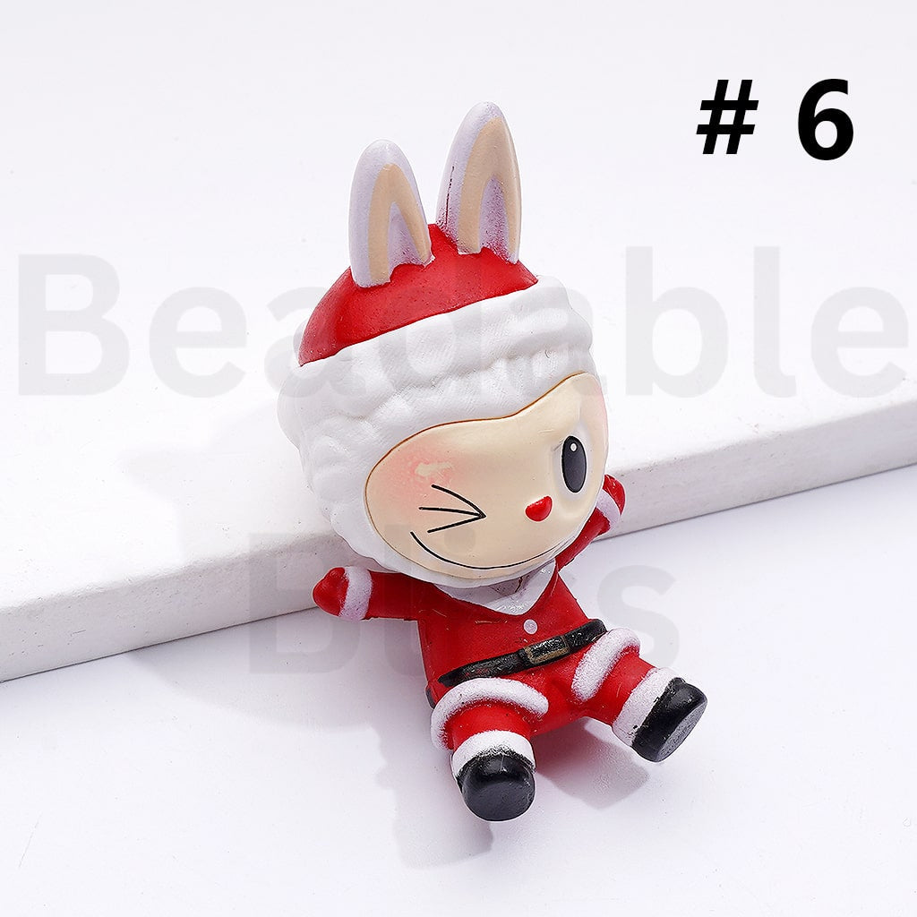 Small plush toy dressed in a Santa outfit on a white background with ' beadablebliss' branding.

