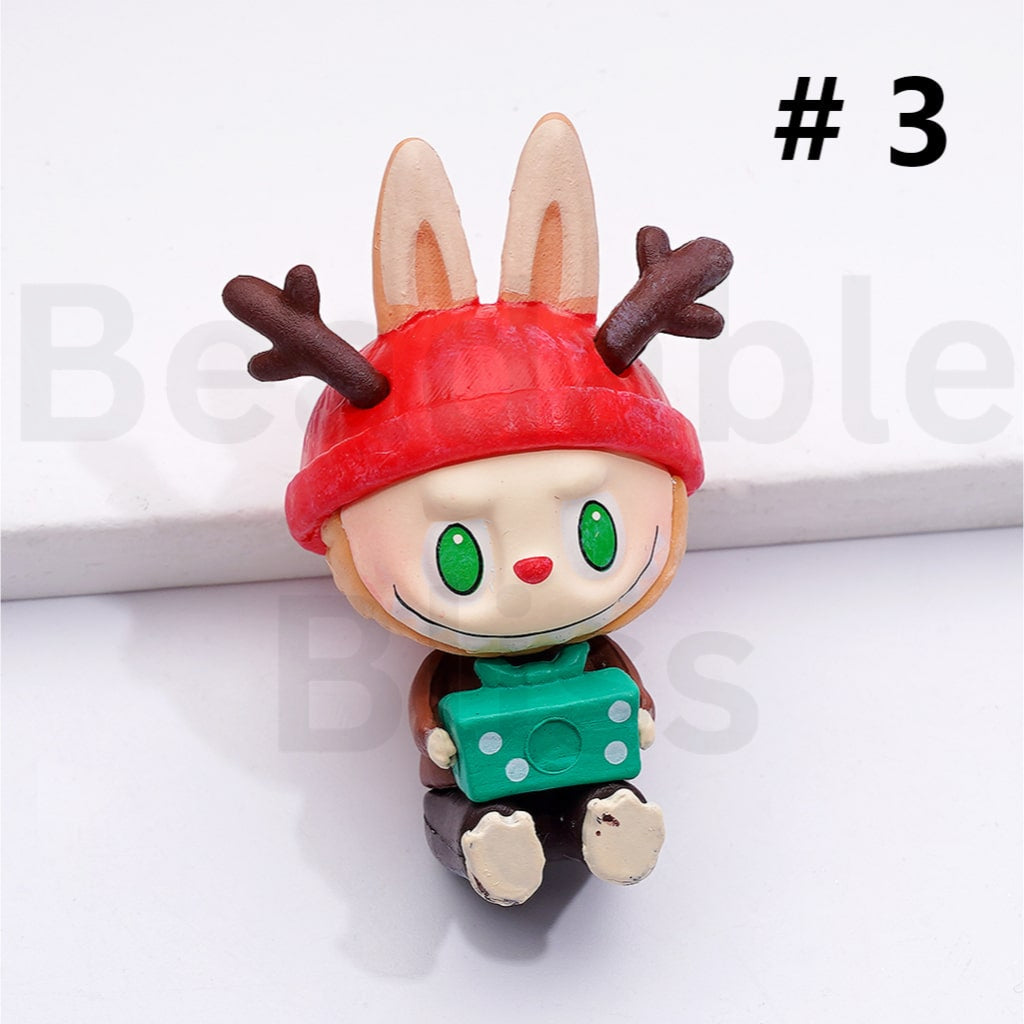 Toy figure with reindeer antlers and a red hat on a white background

