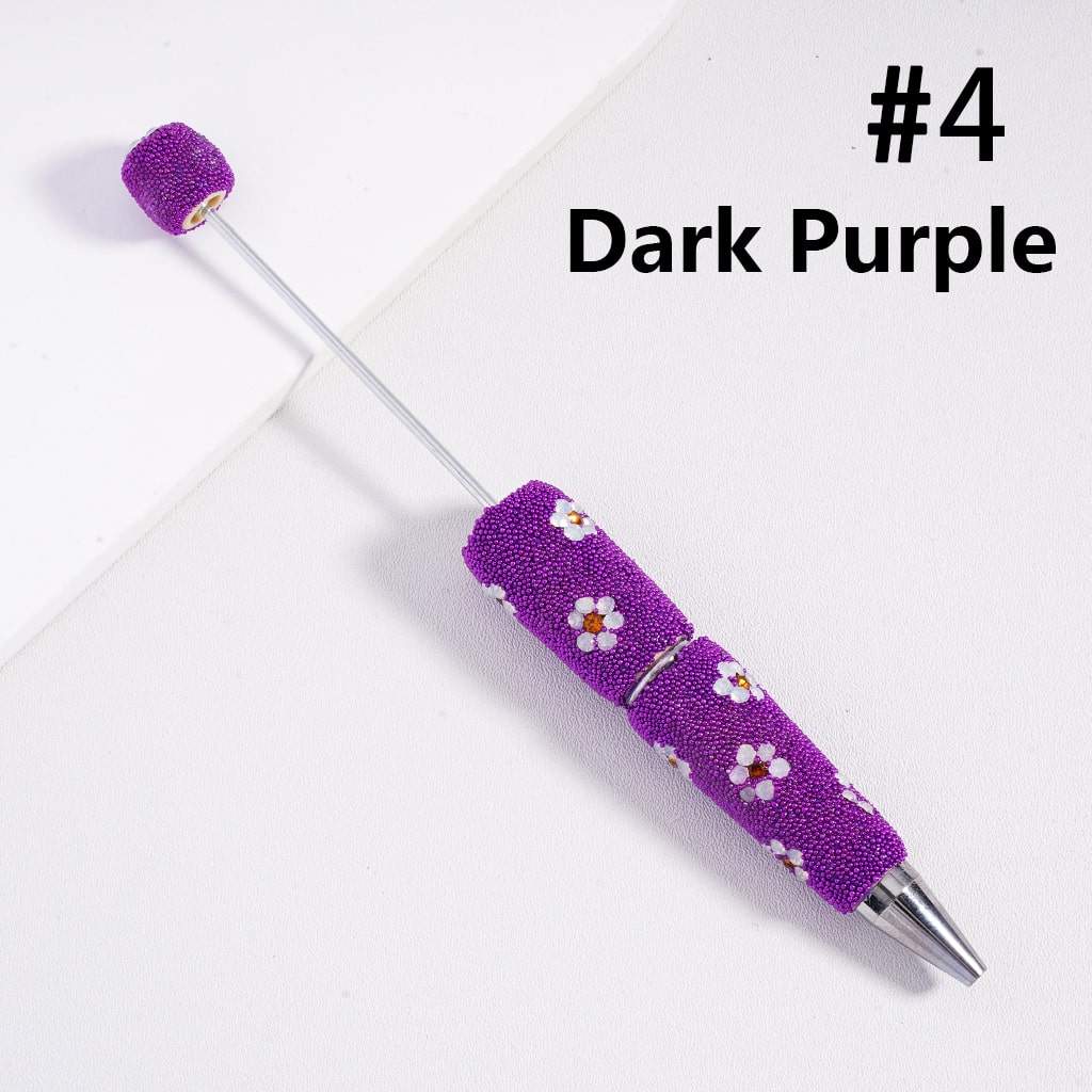 Purple pen with floral design on a white background

