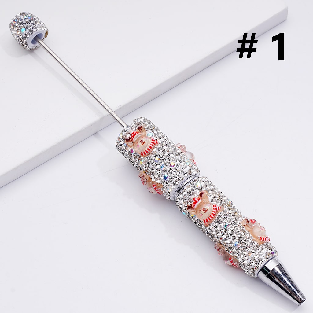 Decorative pen with gemstones and floral design on a white background

