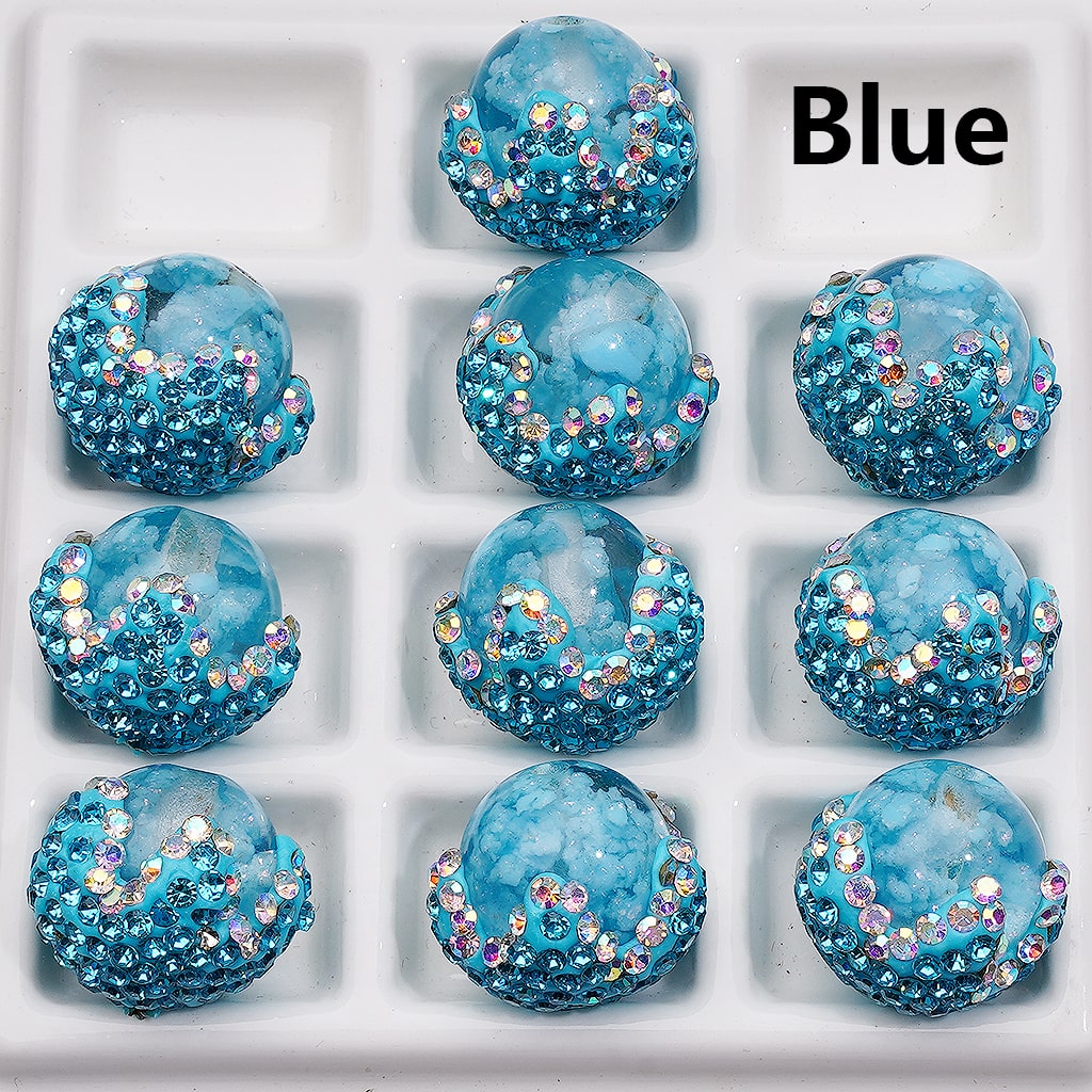 Blue decorative items with glitter on a white tray, labeled 'Blue'.

