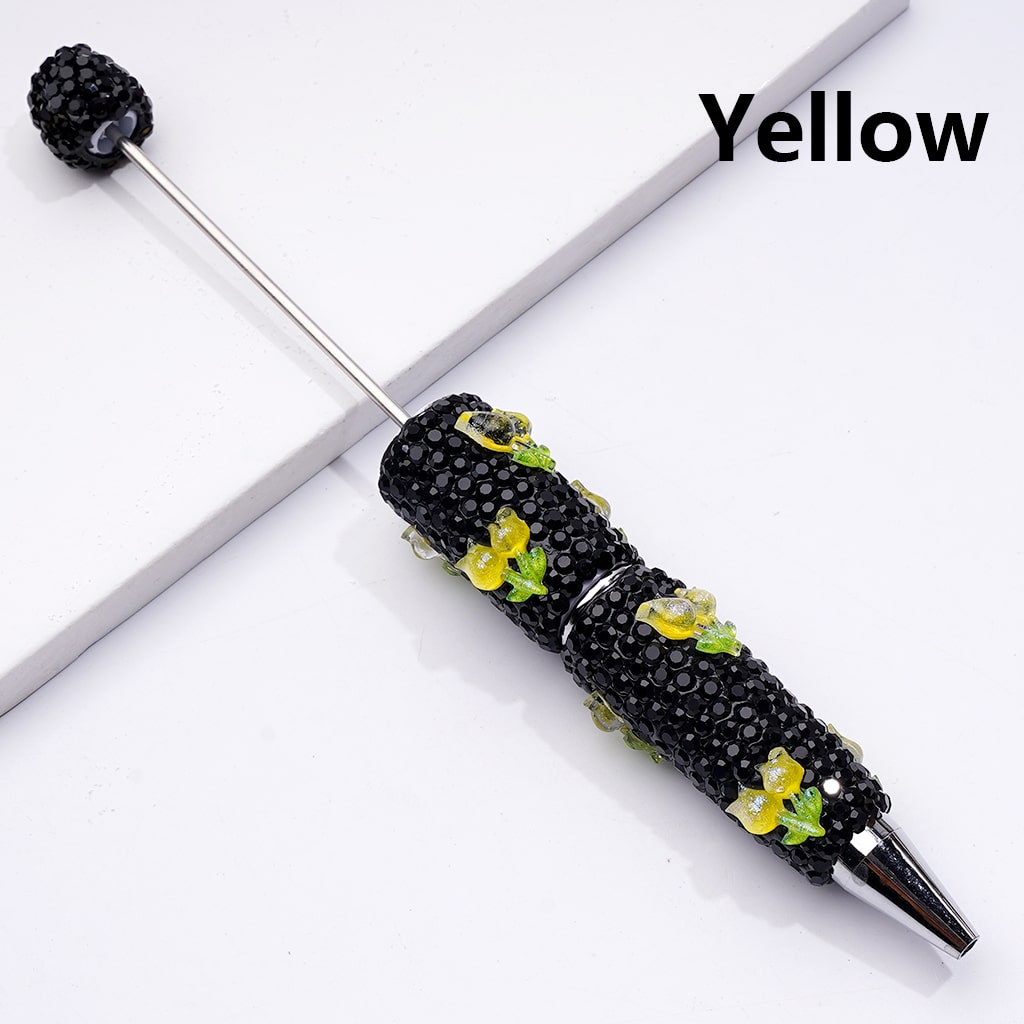 Black decorative pen with yellow accents on a white background

