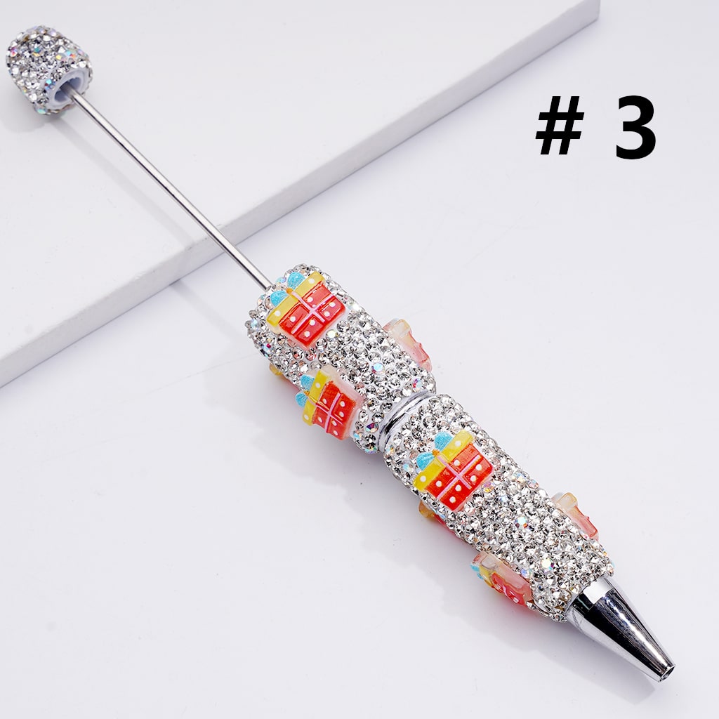 Decorative pen with colorful design and rhinestones on a white background

