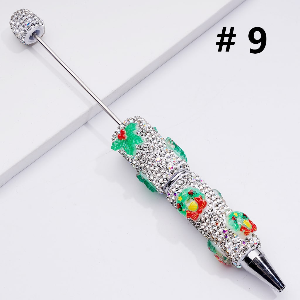 Decorative pen with gemstones and colorful design on a white background

