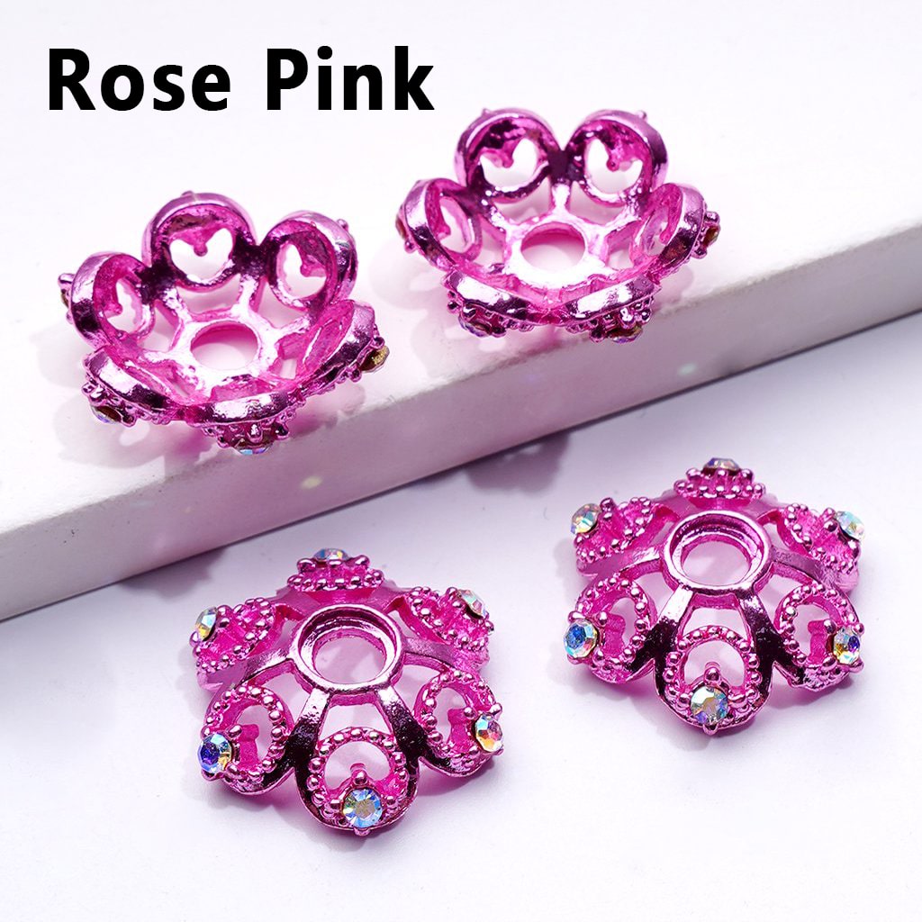 Rose pink decorative items with gemstones on a white background

