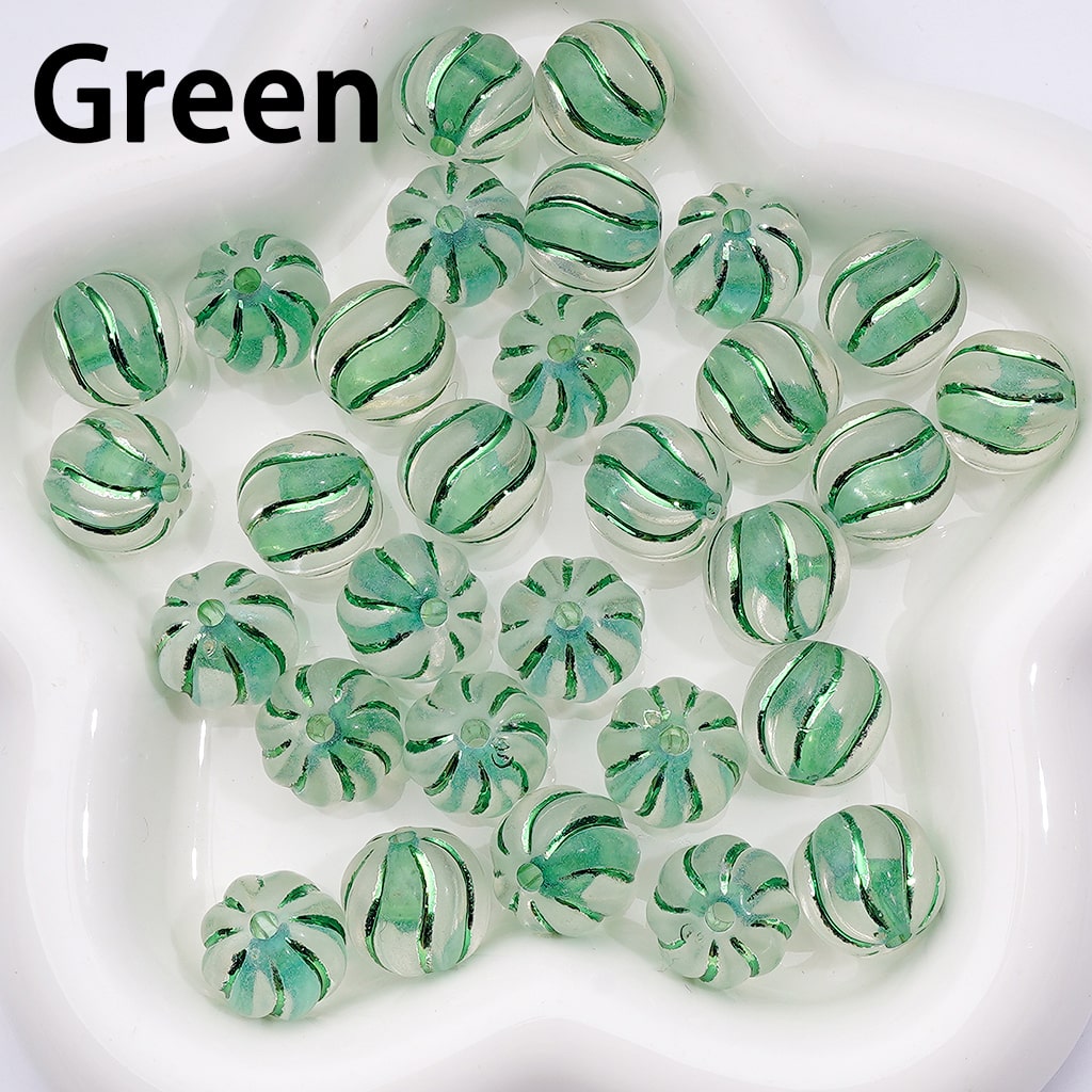 Collection of green glass beads on a white background

