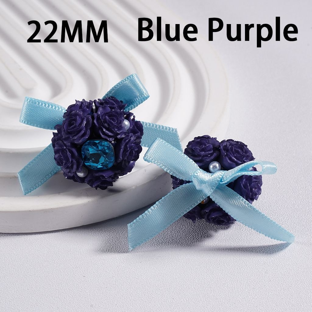 Pair of blue and purple flower earrings with ribbons on a white background

