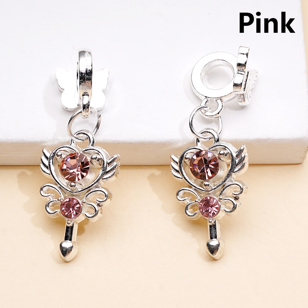 Silver earrings with pink gemstones on a beige background

