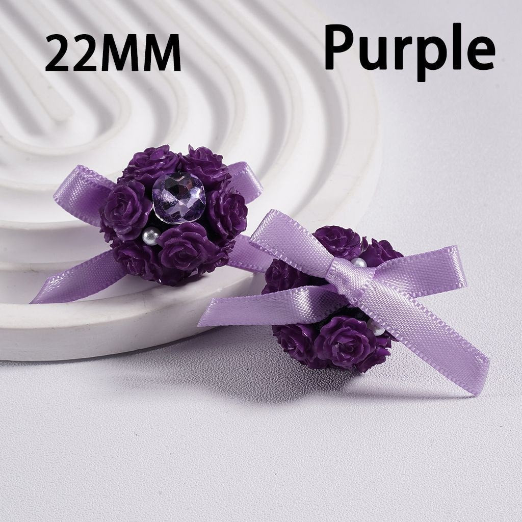 Purple flower corsage with ribbon on a white background

