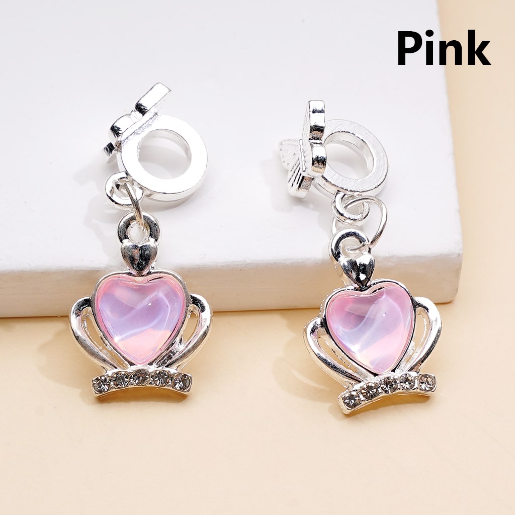 Pink heart-shaped earrings with silver accents on a light background


