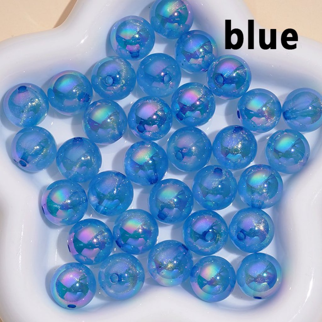 Blue beads with iridescent finish on a white plate, labeled 'blue'.

