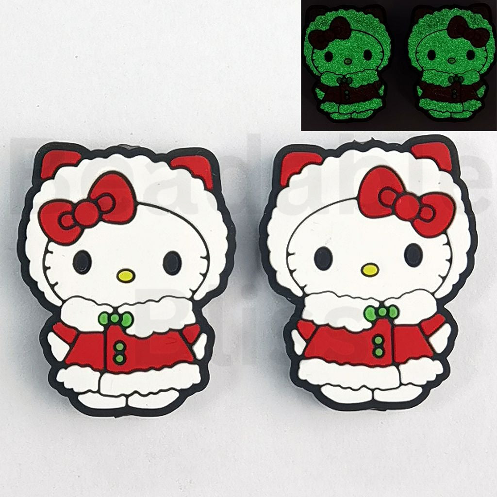Two cartoon character pins with a Santa outfit on a white background.

