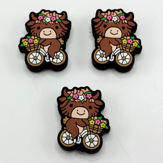 Brown Little Cute Cow Rides a Bike with Small Flowers Silicone Focal Beads