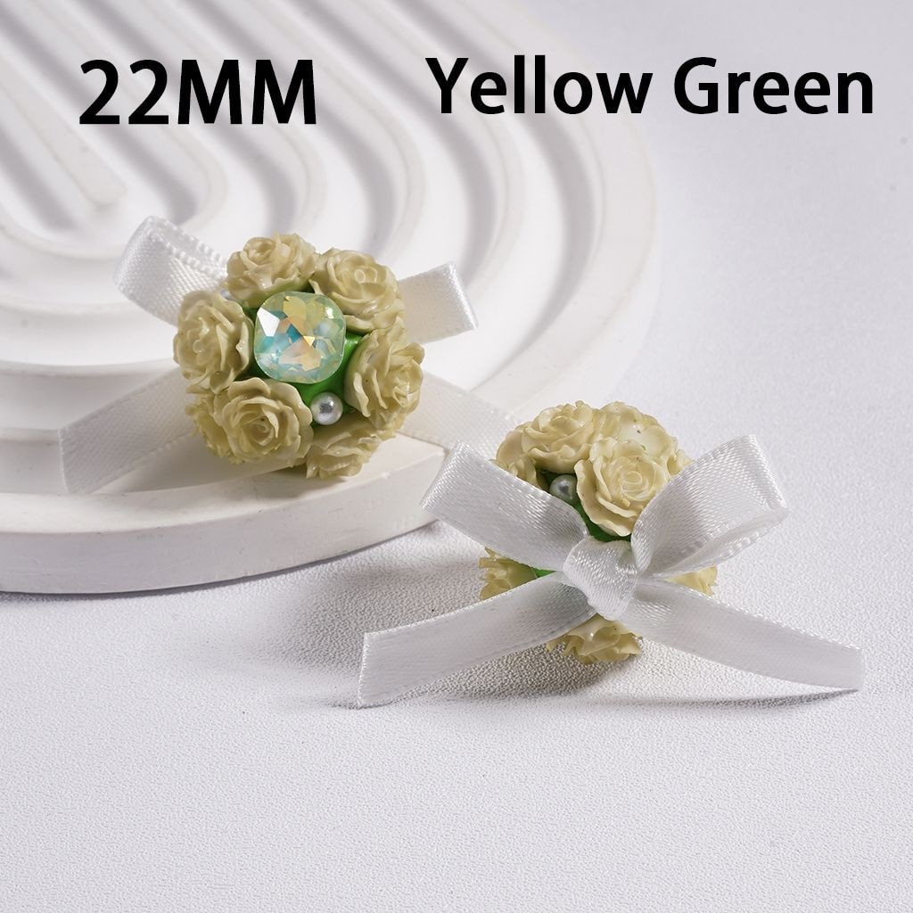 Yellow green flower brooches with white ribbons on a white background

