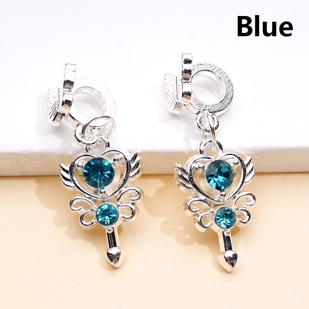Silver earrings with blue gemstones on a beige background

