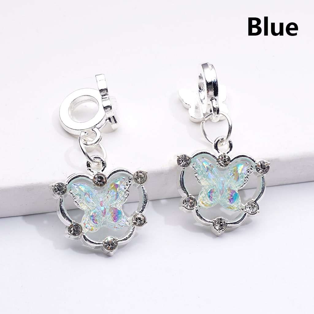 Butterfly-shaped earrings with blue accents on a white background

