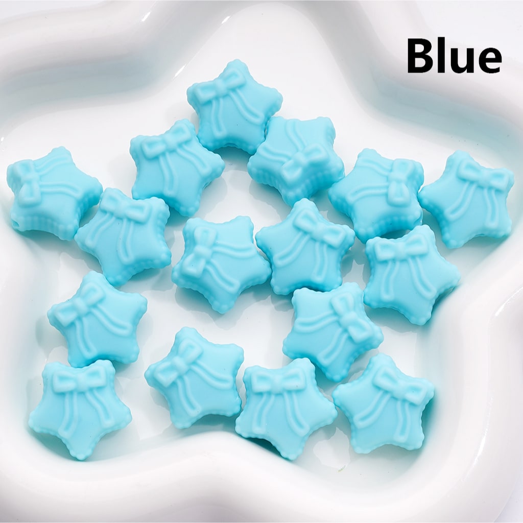 Blue star-shaped candies on a white plate with 'Blue' text.

