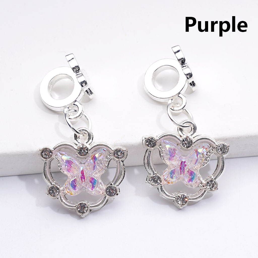 Butterfly-shaped charms with purple accents on a white background

