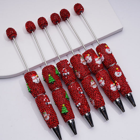 Set of red Christmas-themed pens with silver accents on a white background

