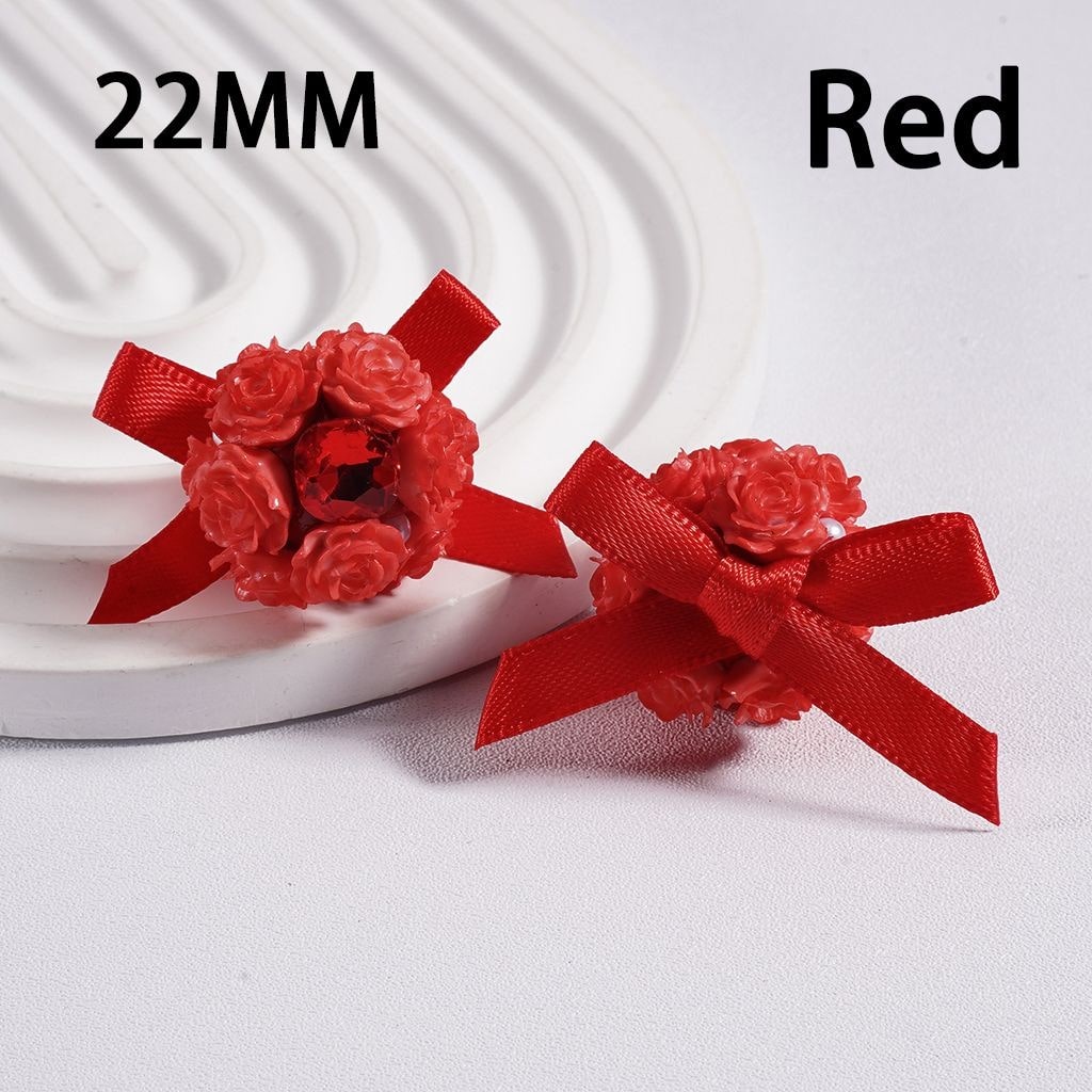 Two red flower-shaped objects with ribbons on a white background, labeled '22MM' and 'Red'.