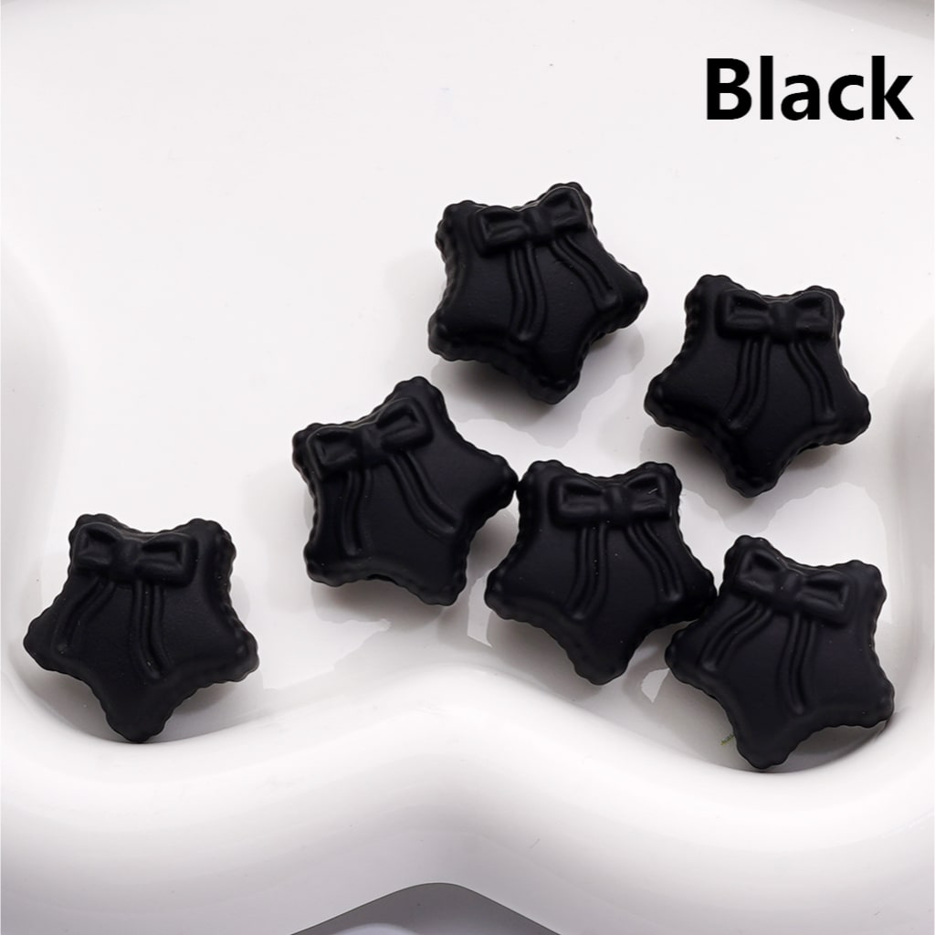 Black decorative items with bow details on a white background

