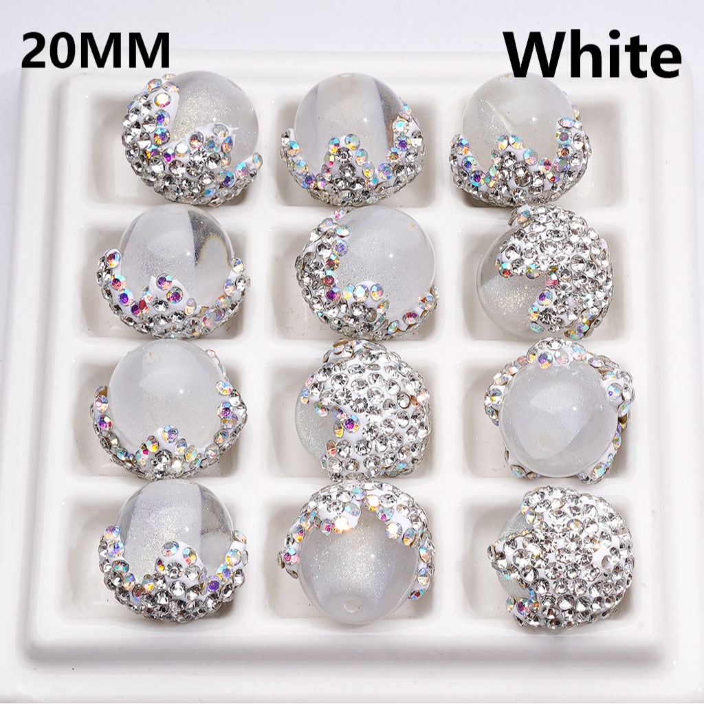 White cabochons with rhinestone embellishments arranged in a grid on a white background.