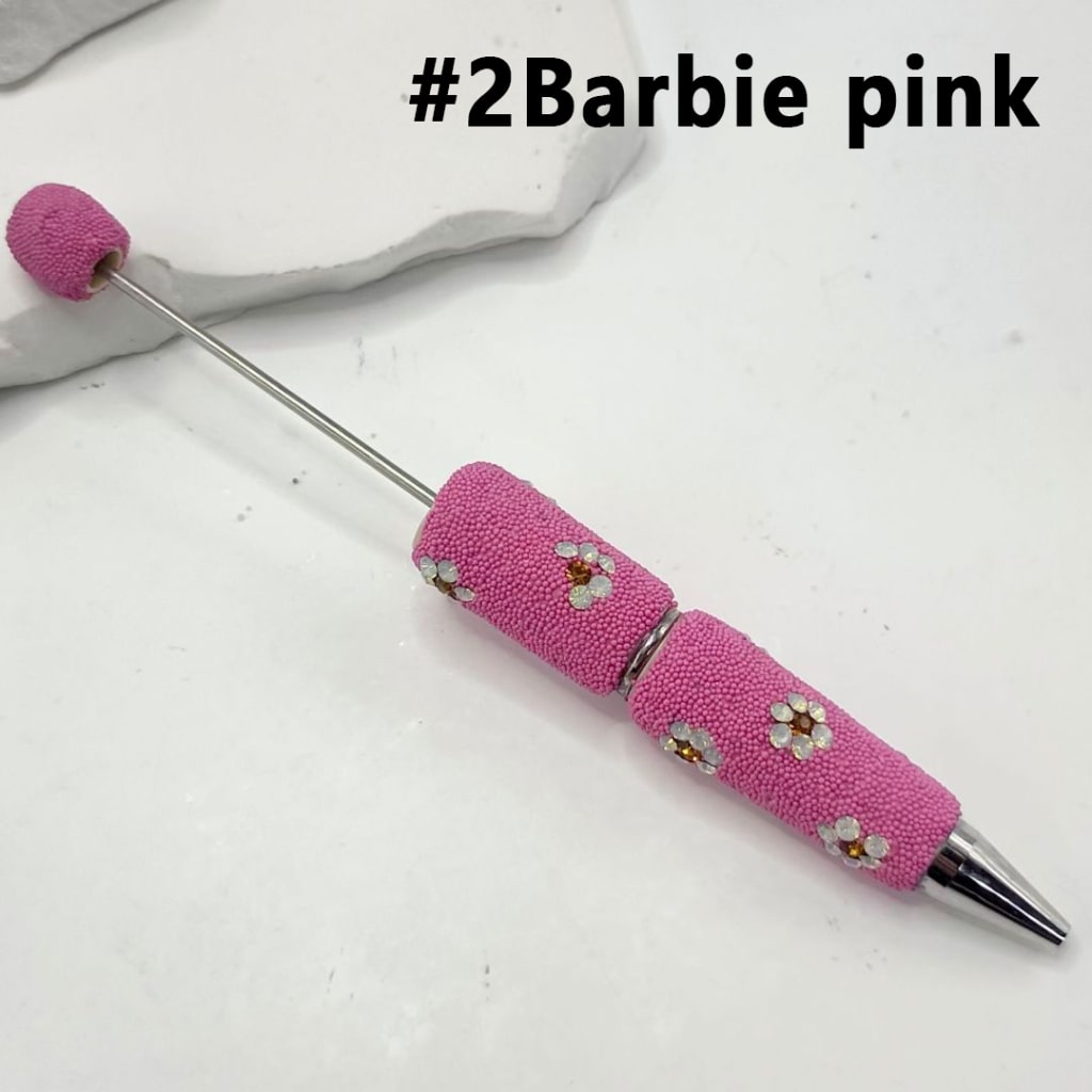 Pink textured pen with decorative elements on a white background


