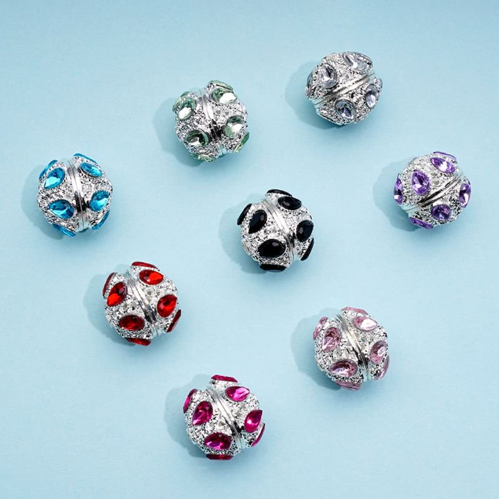 A collection of silver alloy beads with colorful rhinestones, approximately 16mm in size, displayed on a blue background.

