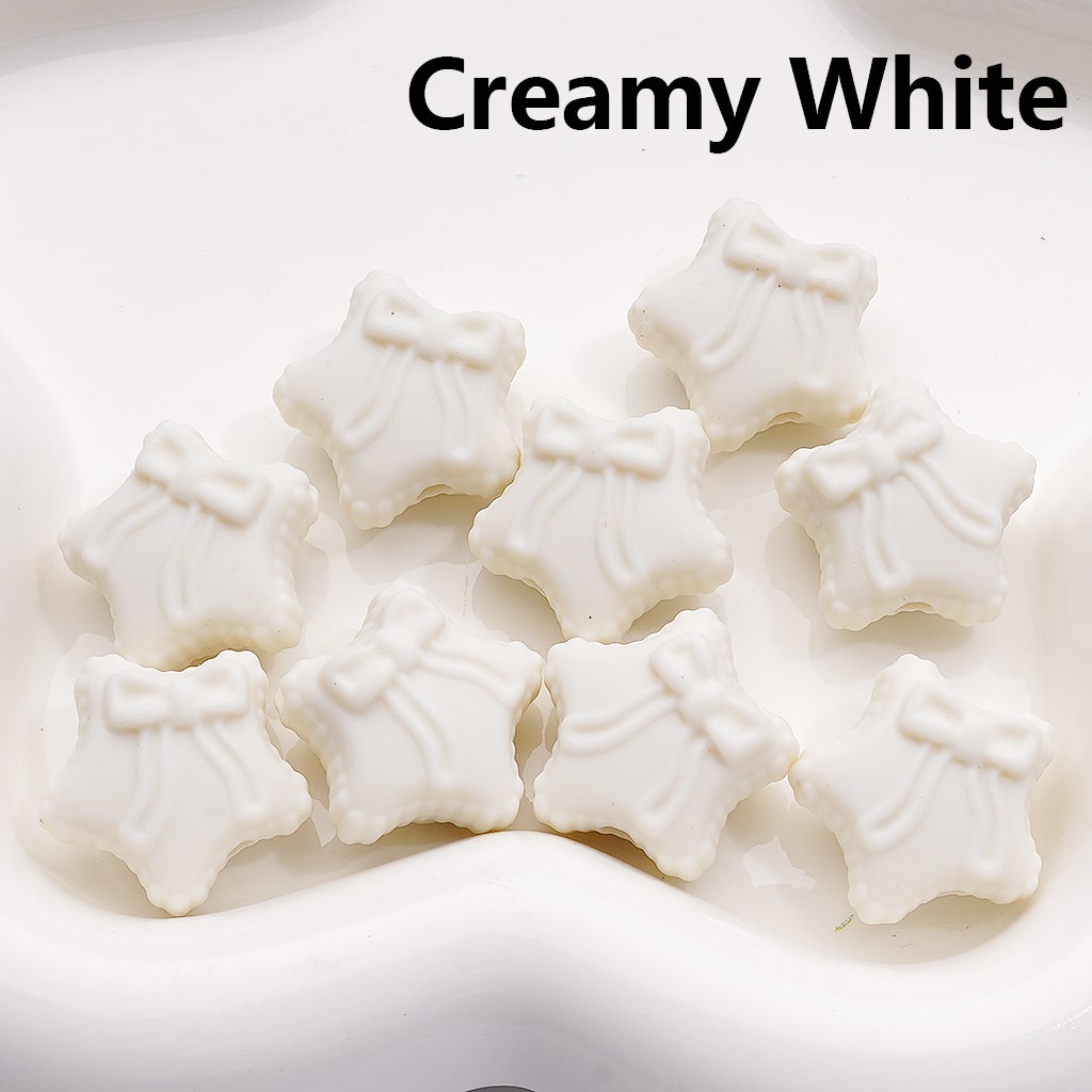 Star-shaped white candies on a white background with 'Creamy White' text.

