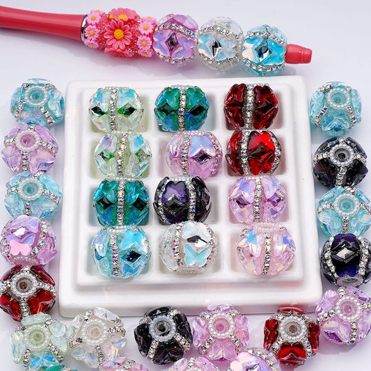 Assorted colorful beads with a white display box on a white background

