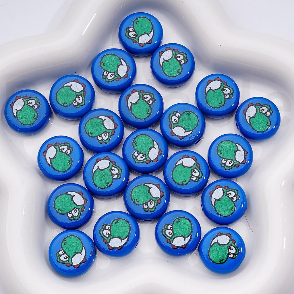 Set of blue buttons with green cartoon characters on a white surface

