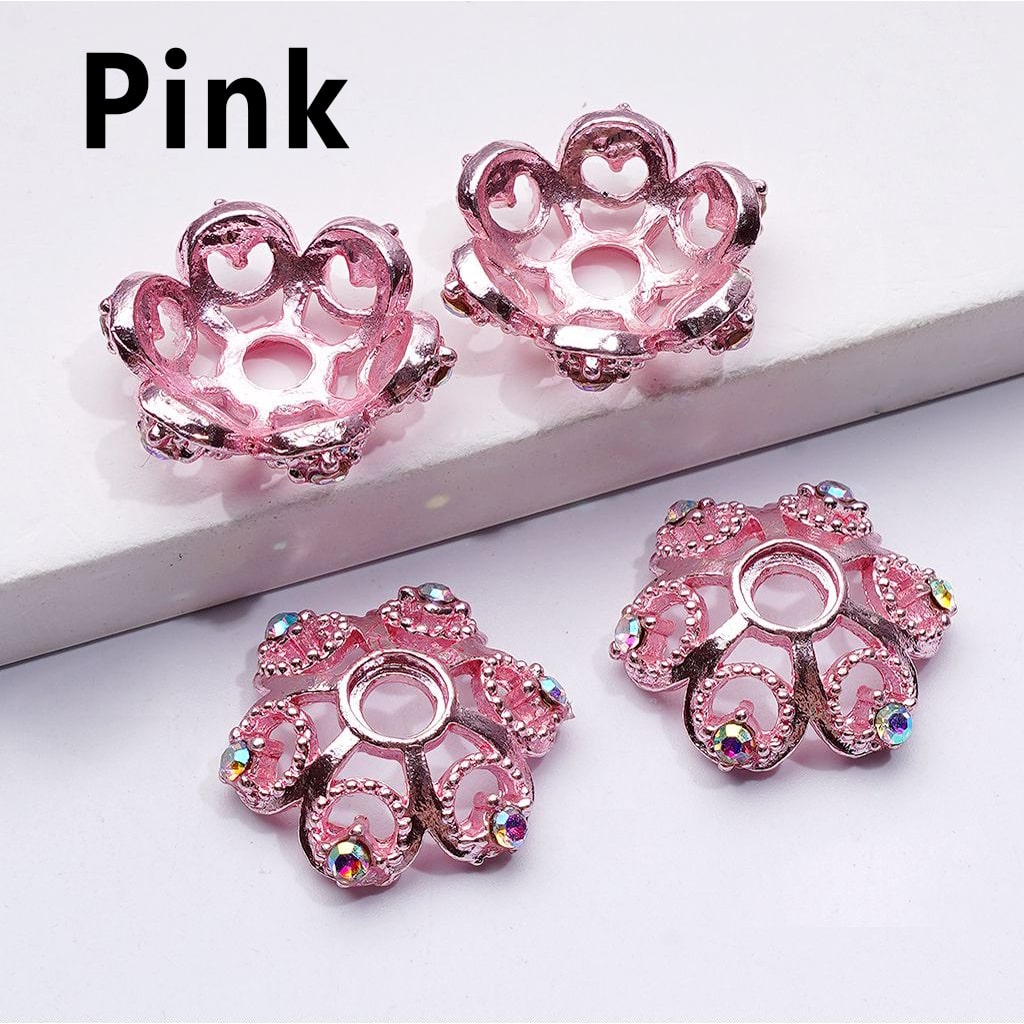 Pink decorative elements with gemstones on a white background

