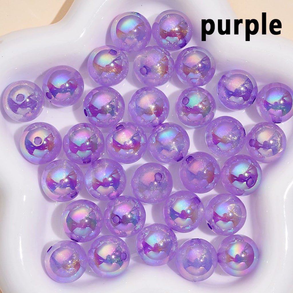 Purple beads with iridescent sheen on a white plate, labeled 'purple'.

