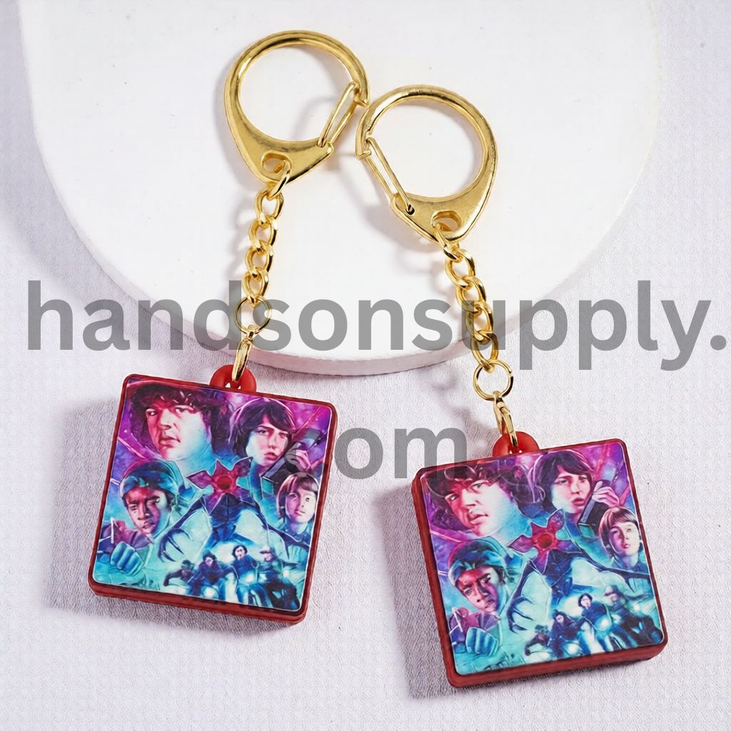 Metal Keychain with Gold Lobster Clasp Red Background & Dark Fantasy Character Design Horror Style Pendant Charm Flat Rectangle Shape