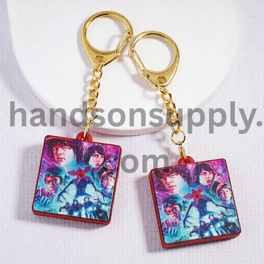 Metal Keychain with Gold Lobster Clasp Red Background & Dark Fantasy Character Design Horror Style Pendant Charm Flat Rectangle Shape