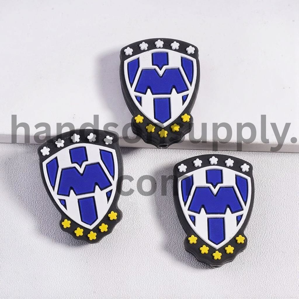 Shield Shape with Blue "M" Text and White & Yellow Colors Blossom Silicone Focal Beads