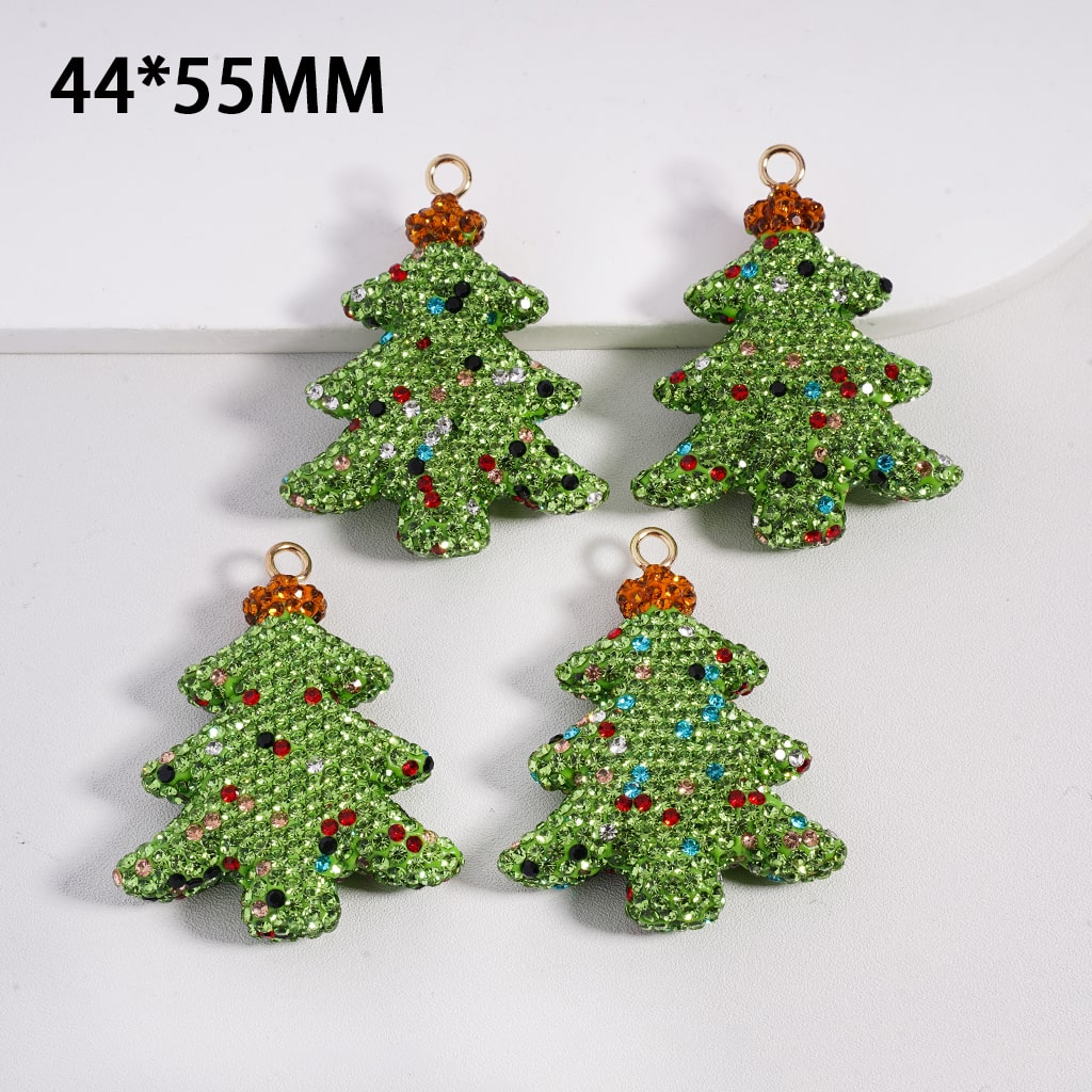 Four green Christmas tree-shaped decorations with rhinestones on a white background.

