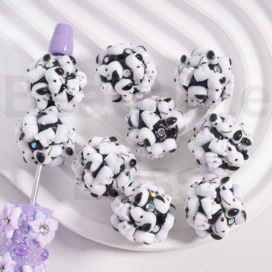 Panda-shaped earrings on a white plate with a light purple background

