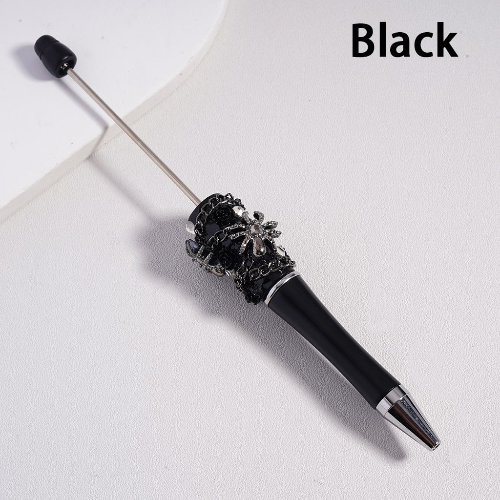 Decorative pen with black and silver design on a white background


