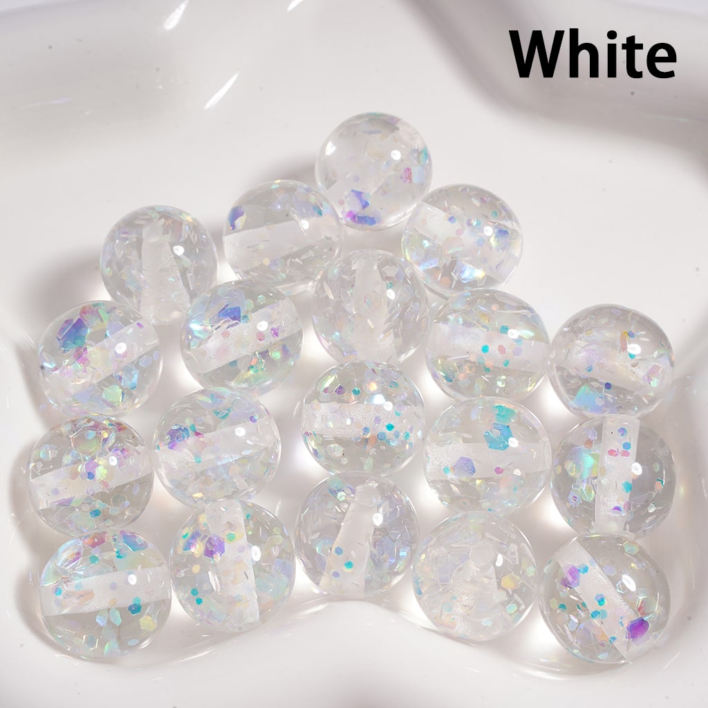 White marbles with glittery specks on a white background

