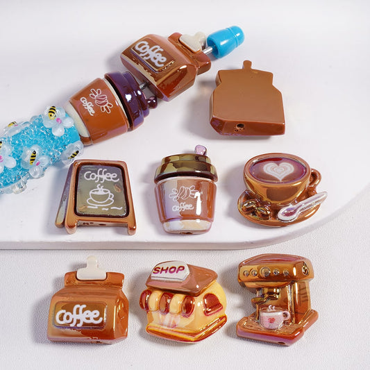 Set of miniature coffee-themed items including bottles, a cup, and a machine on a white background.

