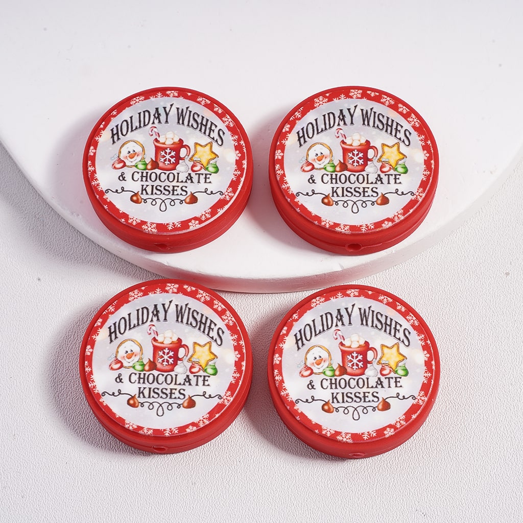 Four red tins labeled 'Holiday Wishes & Chocolate Kisses' on a white surface.

