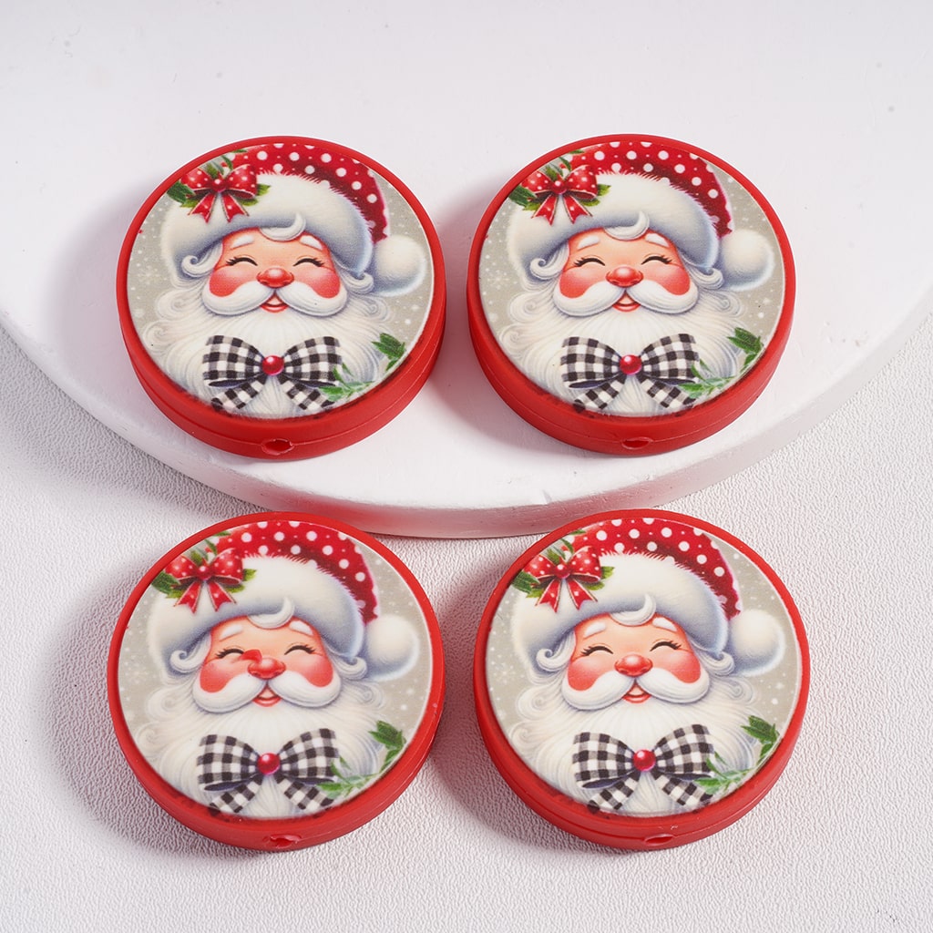 Four round containers with Santa Claus designs on a white plate.

