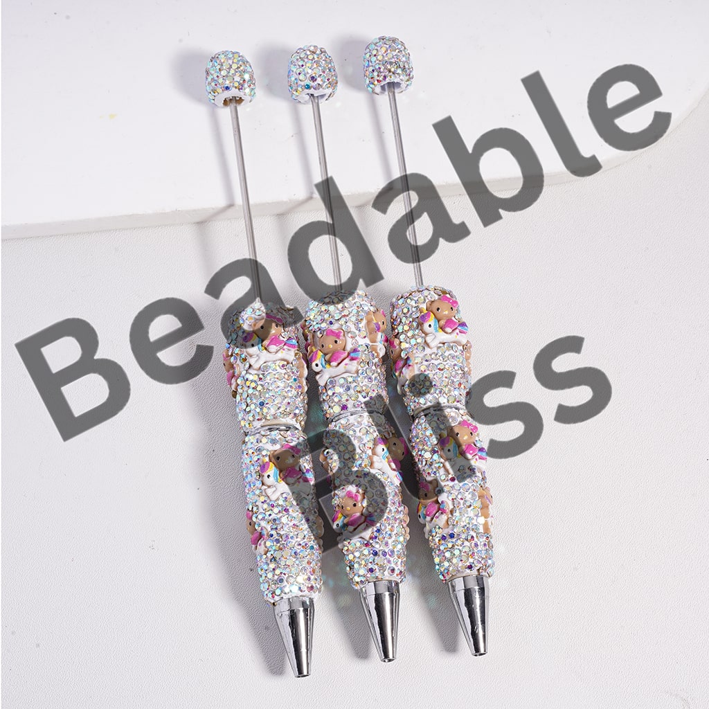 Three decorative pens with floral patterns and rhinestone accents on a white background, branded 'beadablebliss'.

