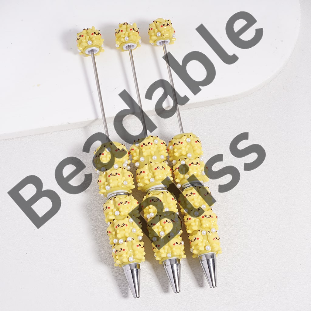 Decorative yellow and silver pen tips on a white background with 'beadablebliss.' branding.

