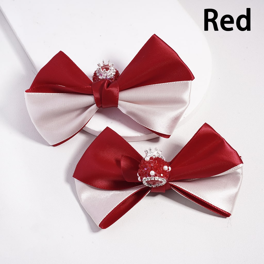 Two red and white bows with decorative elements on a white background

