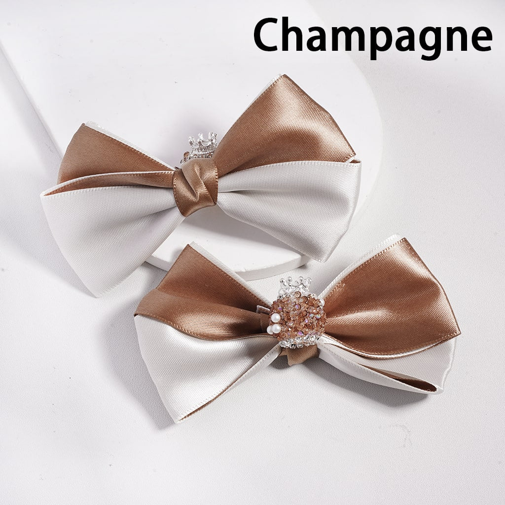 Two satin hair bows with rhinestone centers on a white background, labeled 'Champagne'.

