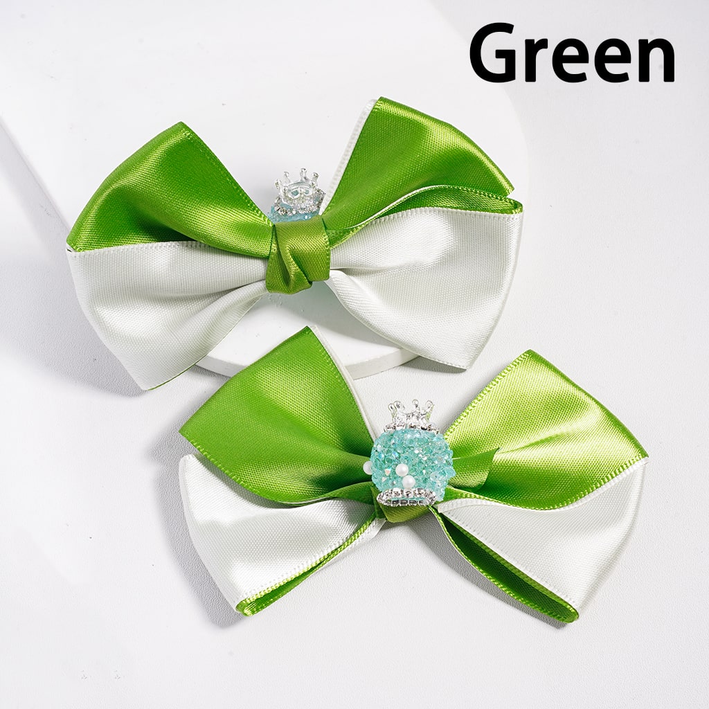 Two green and white bows with decorative elements on a white background

