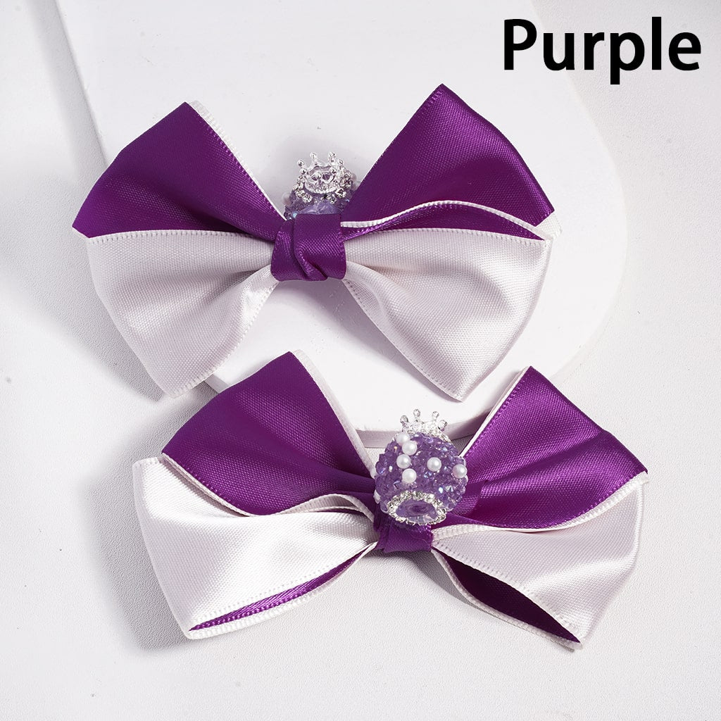 Two purple and white bows with decorative elements on a white background

